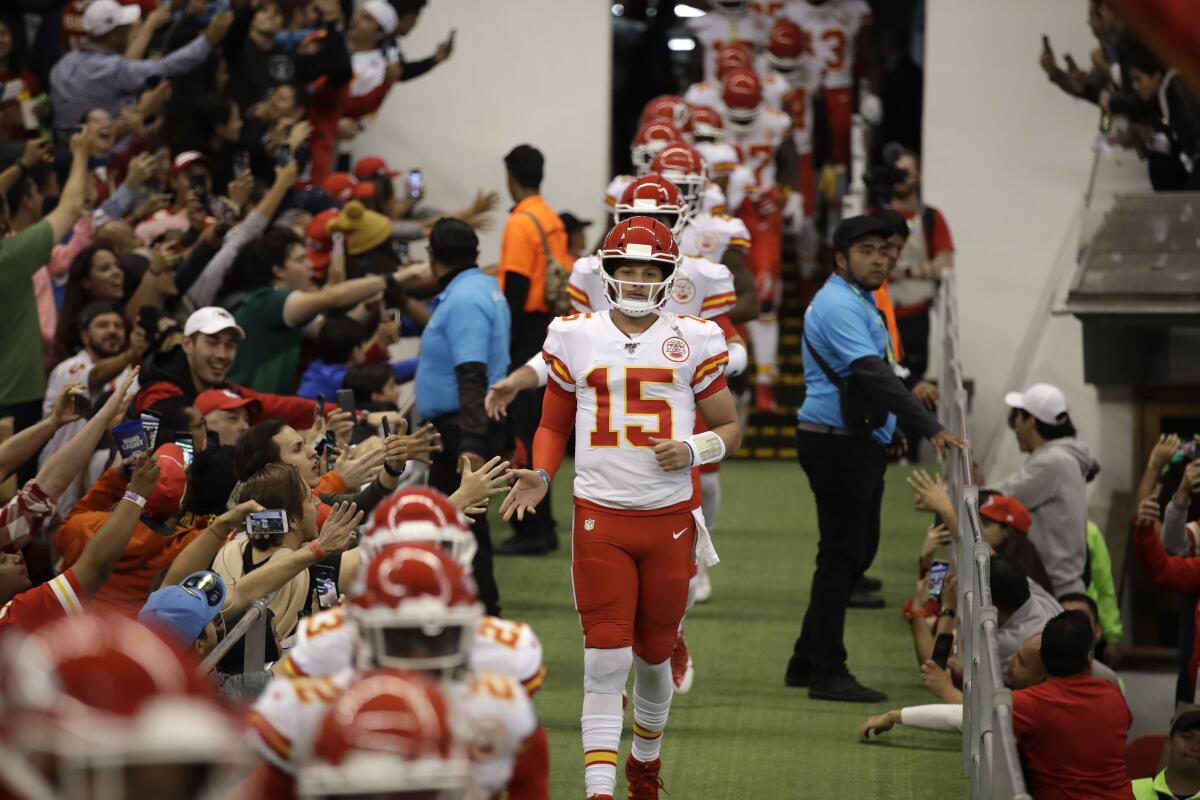 Kansas City Chiefs quarterback Patrick Mahomes (15) leads his teammates onto the field before their game against the Chargers on Nov. 18 at Aztec Stadium in Mexico City.