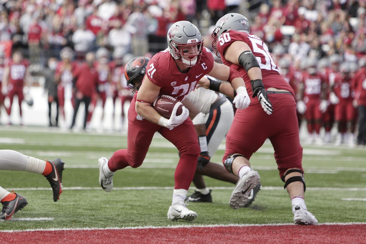 Washington State running back Max Borghi (21) runs for a touchdown during the second half of an NCAA college football game against Oregon State, Saturday, Oct. 9, 2021, in Pullman, Wash. Washington State won 31-24. (AP Photo/Young Kwak)