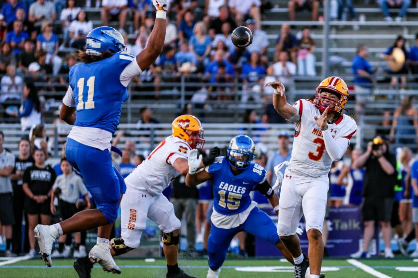 Mission Viejo QB Luke Fahey, an Ohio State commit, fires pass over USC commit Simote Katoanga of Santa Margarita.