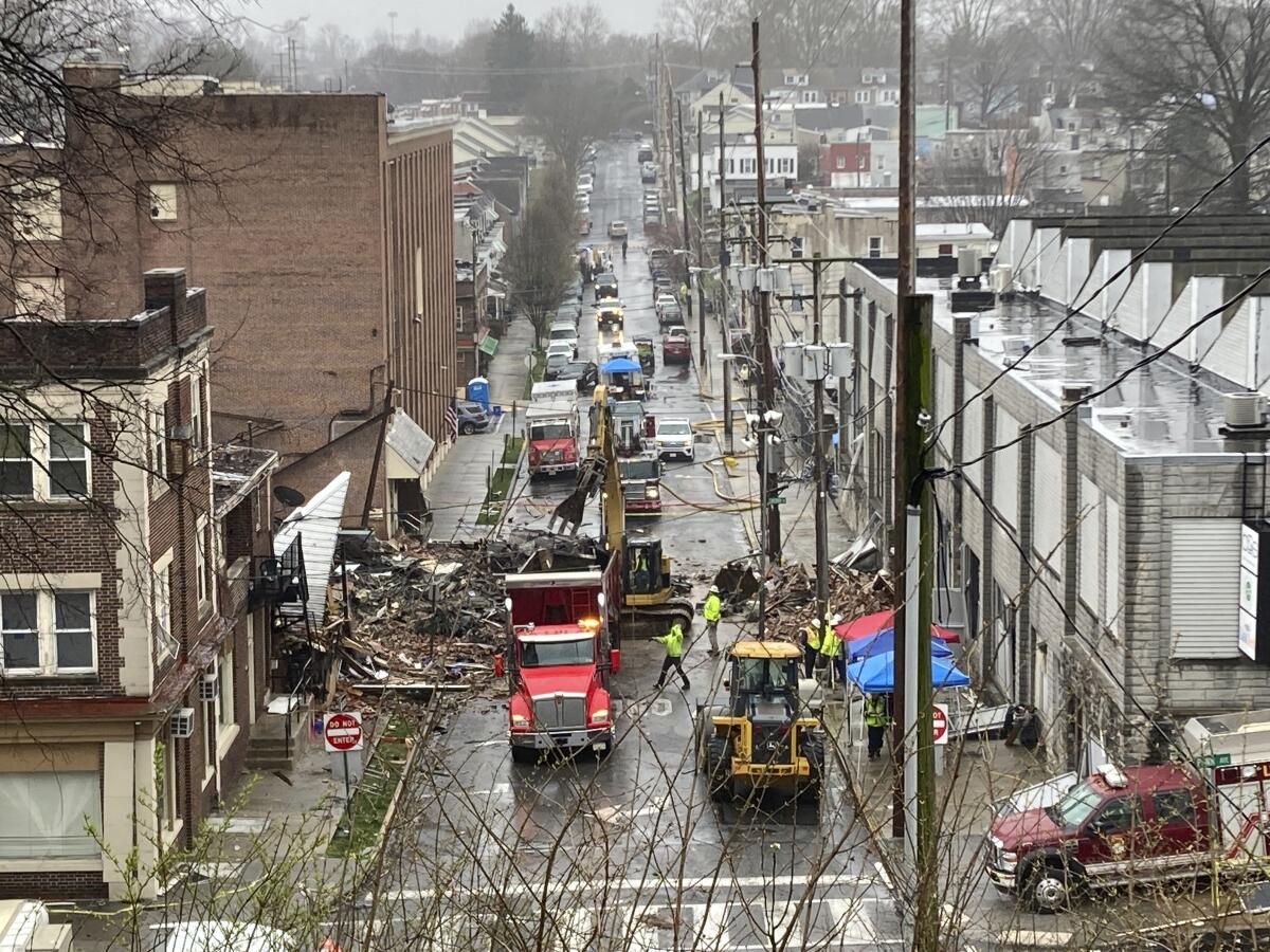 Emergency responders at the site of a deadly chocolate factory explosion