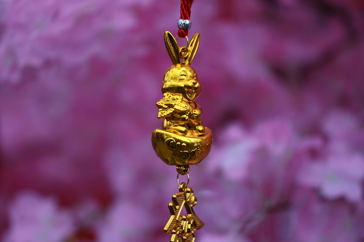 A rabbit ornament hangs from a pink cherry blossom tree at the Alhambra Lunar New Year Festival.