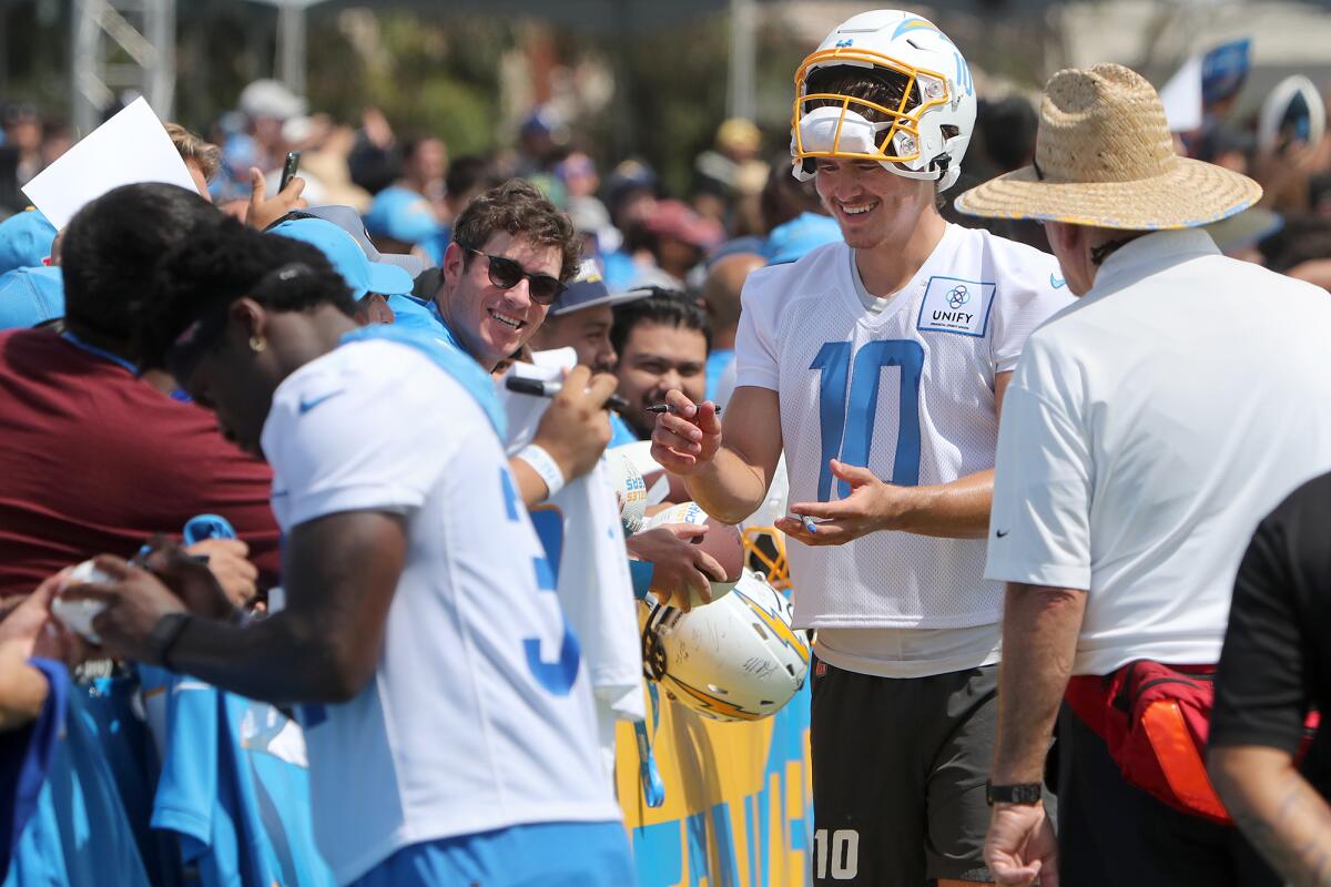  Justin Herbert (10) greets fans as he signs autographs during the first day of Los Angeles Chargers training camp.