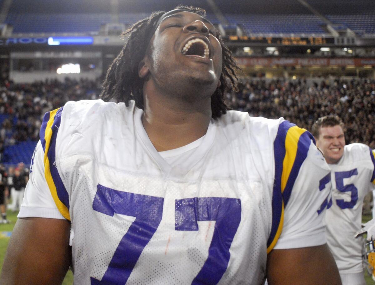 Seantrel Henderson celebrates a high school win on Nov. 27, 2009.