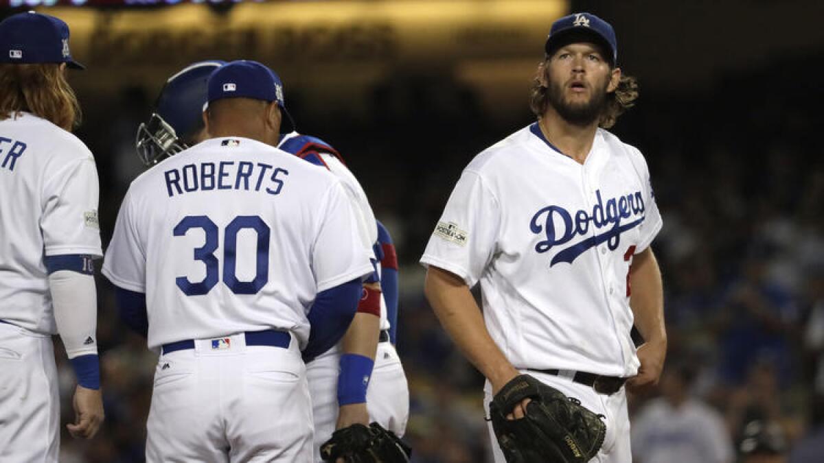 Clayton Kershaw waits for his replacement after giving up back-to-back home runs and being pulled by manager Dave Roberts in the seventh inning of Game 1 against Arizona.