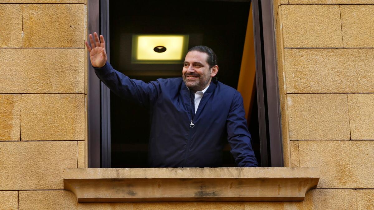 Lebanese Prime Minister Saad Hariri waves Nov. 22 from his residence, in Beirut, Lebanon.