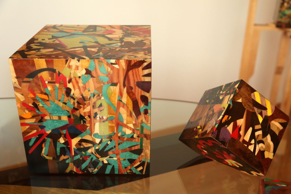 A pair of marquetry cubes.
