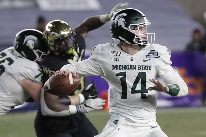 Michigan State's Brian Lewerke (14) throws a pass during the second half of the team's Pinstripe Bowl NCAA college football game against Wake Forest on Friday, Dec. 27, 2019, in New York. Michigan State won 27-21. (AP Photo/Frank Franklin II)