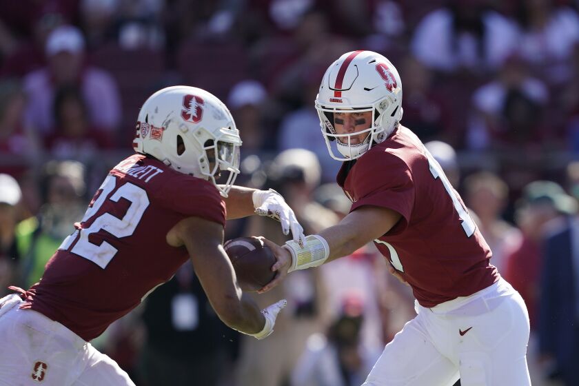 Stanford quarterback Davis Mills (15) hands off to running back Cameron Scarlett (22) against Northwestern during the second half of an NCAA college football game on Saturday, Aug. 31, 2019, in Stanford, Calif. (AP Photo/Tony Avelar)