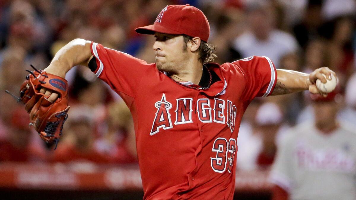 Angels starter C.J. Wilson delivers a pitch during the fourth inning of the team's 7-2 win over the Philadelphia Phillies on Aug. 12.