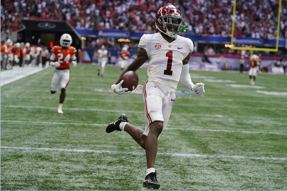 Alabama wide receiver Jameson Williams (1) scores after a catch during the second half of an NCAA college football game against Miami, Saturday, Sept. 4, 2021, in Atlanta. (AP Photo/John Bazemore)