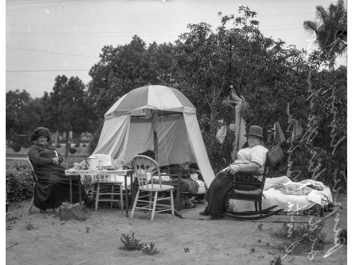 June 1925: Santa Barbara residents living in tent following 6.8 earthquake of June 29, 1925. Handwritten on negative: "People living outside after quake, Santa Barbara." Handwritten information was often added on edges of 4-by-5 inch negatives for archival purposes.