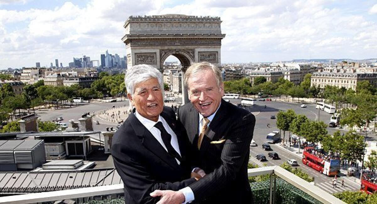 Maurice Levy, left, chief executive of French advertising group Publicis, and John Wren, head of Omnicom Group, pose during a joint news conference in Paris over the weekend. Publicis and Omnicom have announced merger plans to create the world's biggest advertising group.