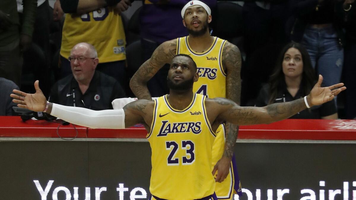 Lakers forward LeBron James expresses frustration while watching a video replay in his return game against the Clippers on Thursday.