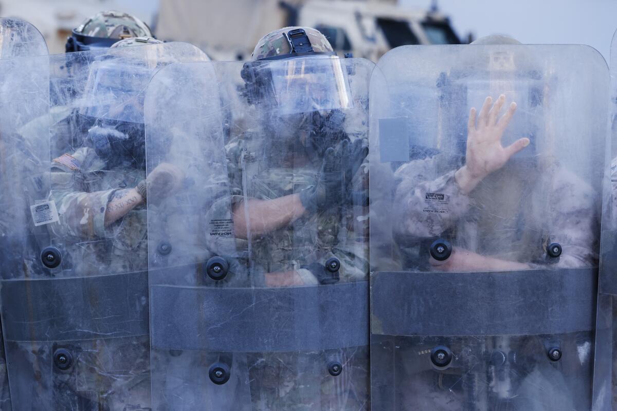 LOS ANGELES, CA - July 4: Marines and National Guard guards perform an ice raid in the city in front of the Edward R. Roybal federal building in Los Angeles, California on Friday, July 4, 2025. (Carlin Stiehl/Los Angeles Times)