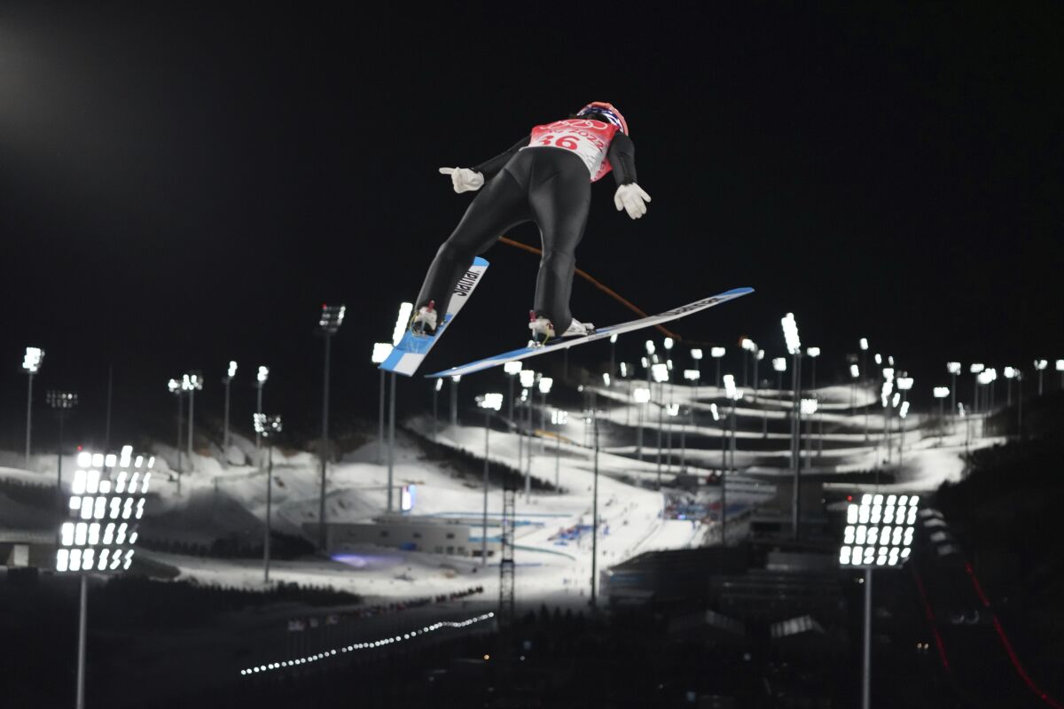 Sara Takanashi, of Japan, soars through the air during the women's normal hill individual ski jumping trial round at the 2022 Winter Olympics, Saturday, Feb. 5, 2022, in Zhangjiakou, China. (AP Photo/Matthias Schrader)