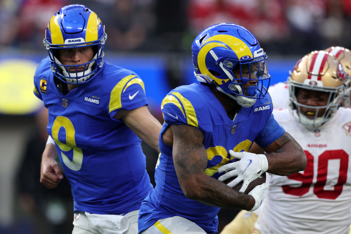 Rams quarterback Matthew Stafford, left, hands off the ball to running back Cam Akers against the 49ers on Sunday.