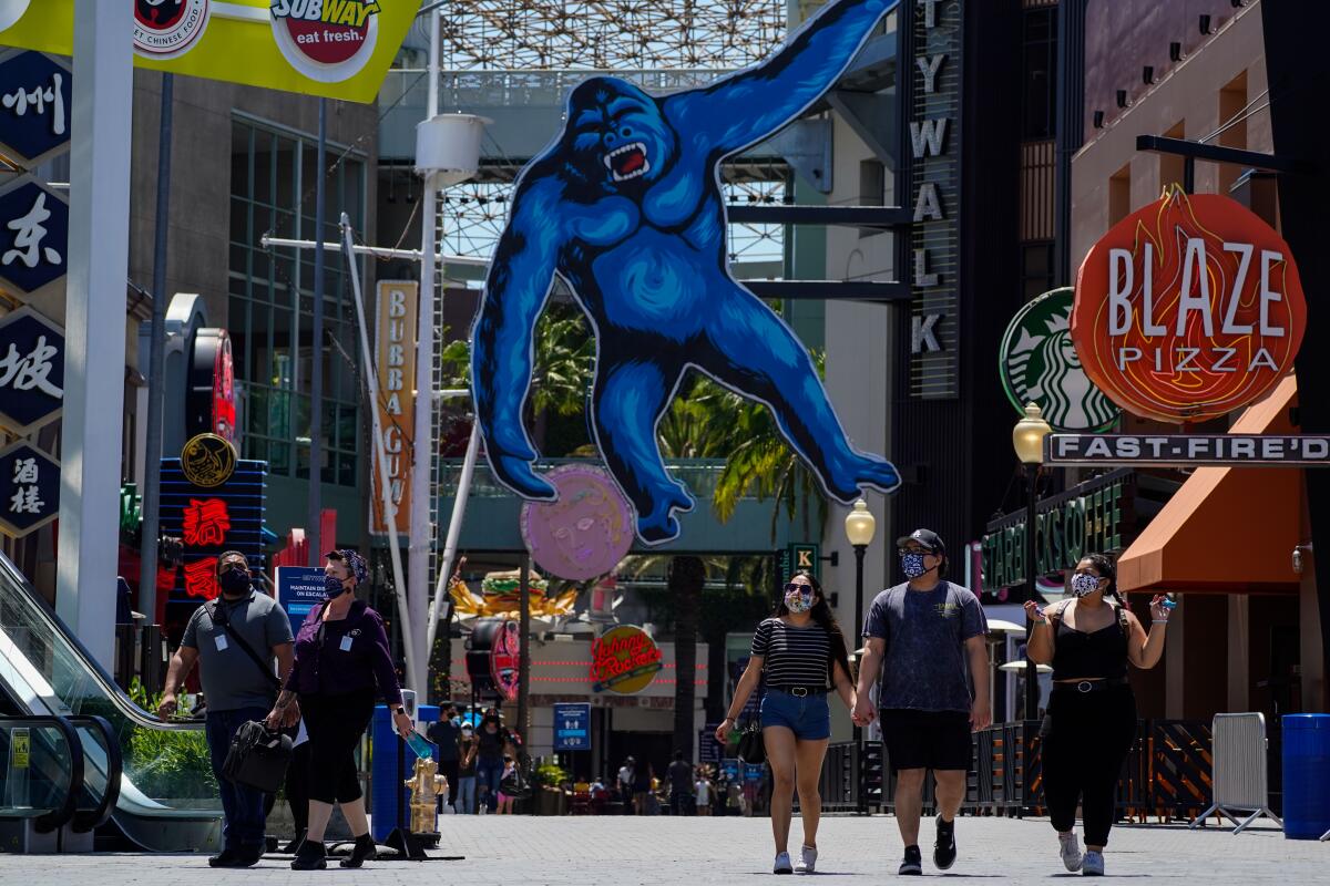  People stroll through Universal CityWalk in Los Angeles on Thursday.