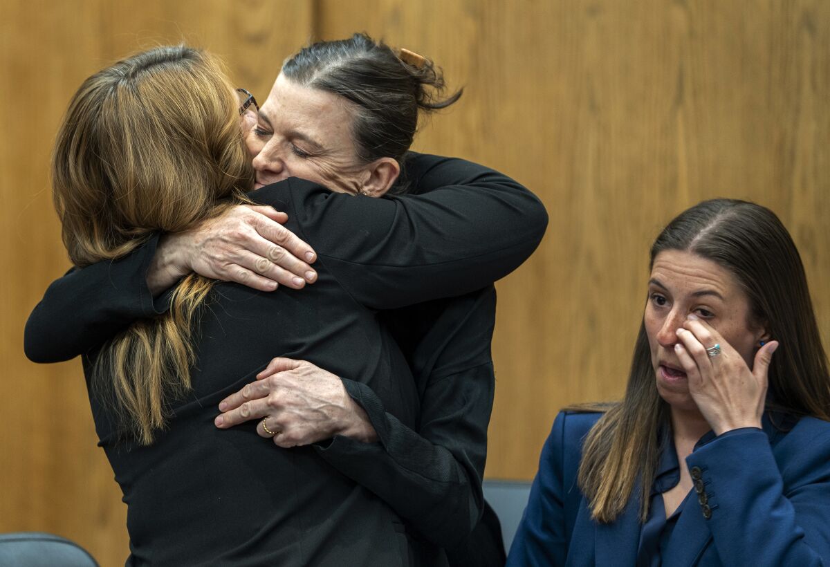Dr. Giovannina Anthony, second from left, an OB/GYN and plaintiff in a lawsuit challenging Wyoming's new law banning most abortions, hugs her attorney after Ninth District Court Judge Melissa Owens issued a temporary halt of the law, Wednesday, March 22, 2023, in Jackson, Wyo. (Kathryn Ziesig/Jackson Hole News & Guide via AP)