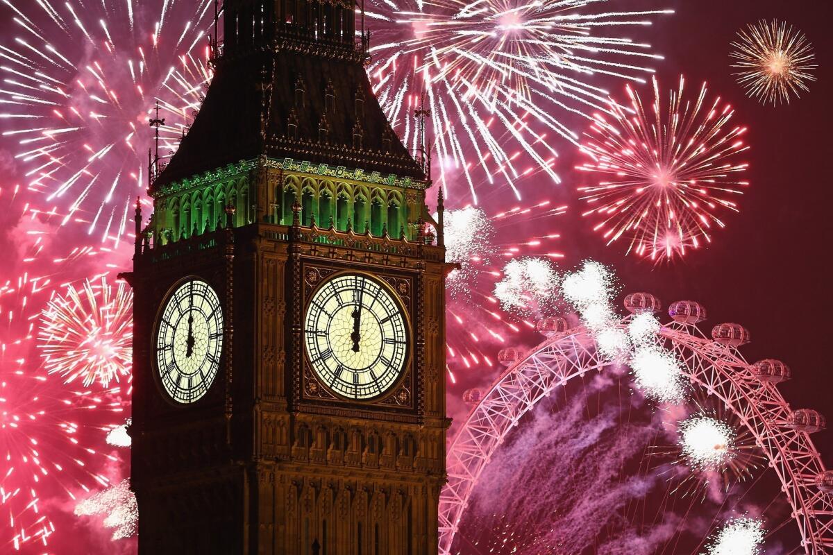 Fireworks light up the London Eye and Big Ben just after midnight.