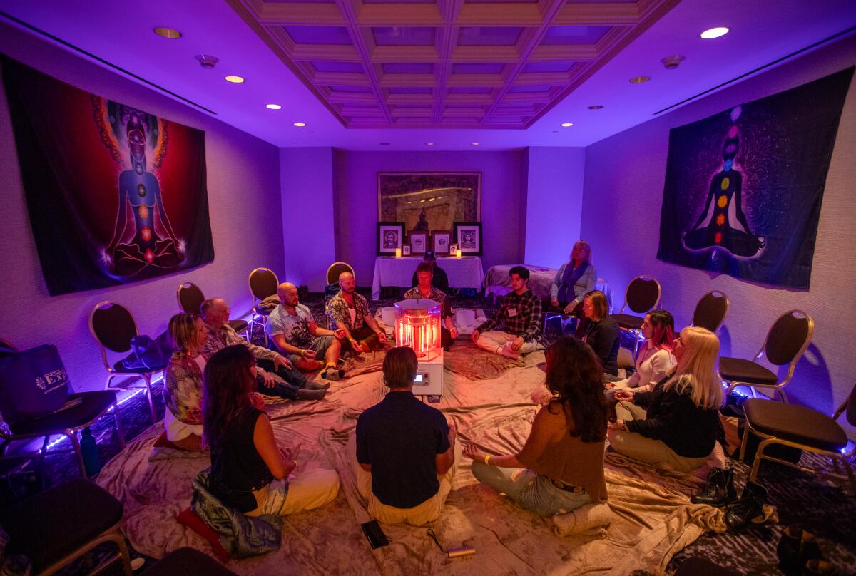 People participate in a Tesla biocharged meditation session during the Conscious Life Expo.