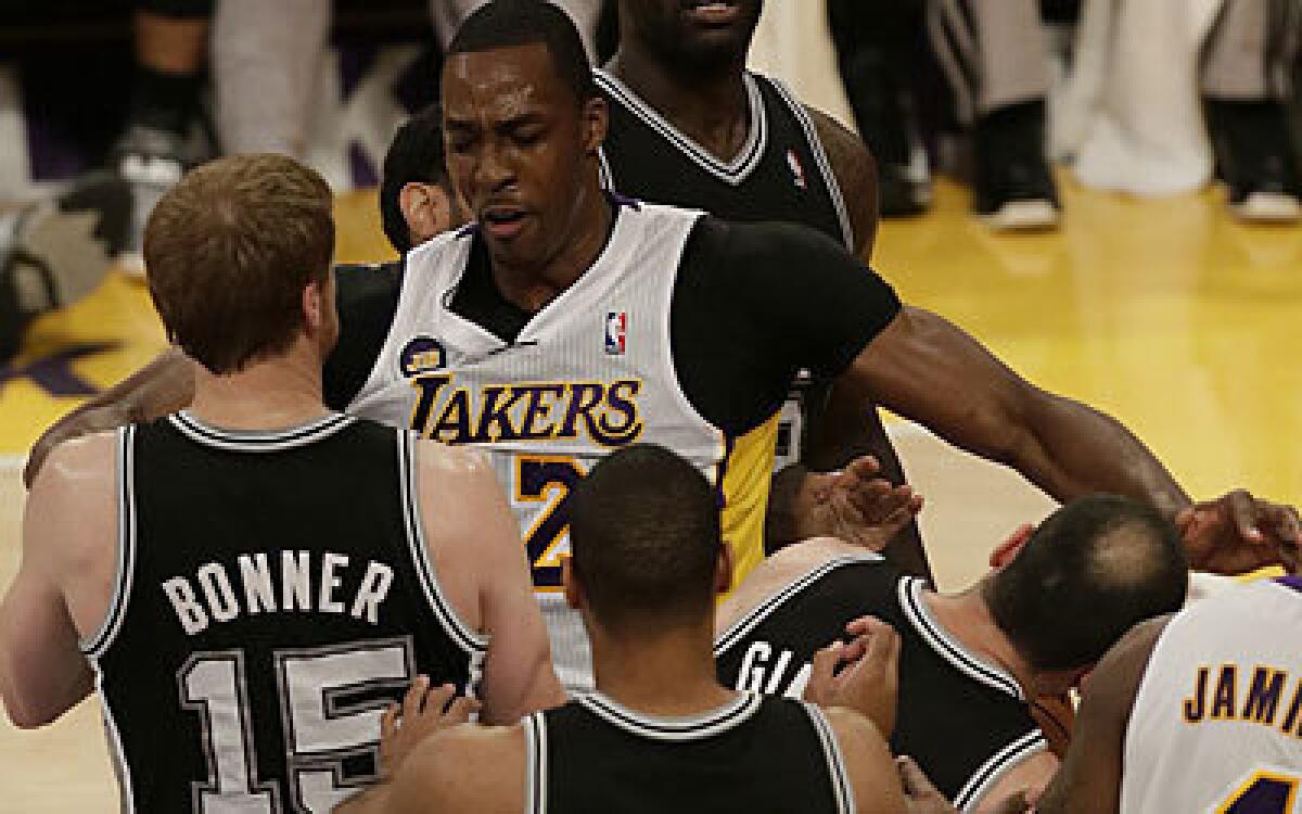 Lakers center Dwight Howard smacks Manu Ginobili of the Spurs, resulting in a technical foul, in the first quarter of Sunday's game.