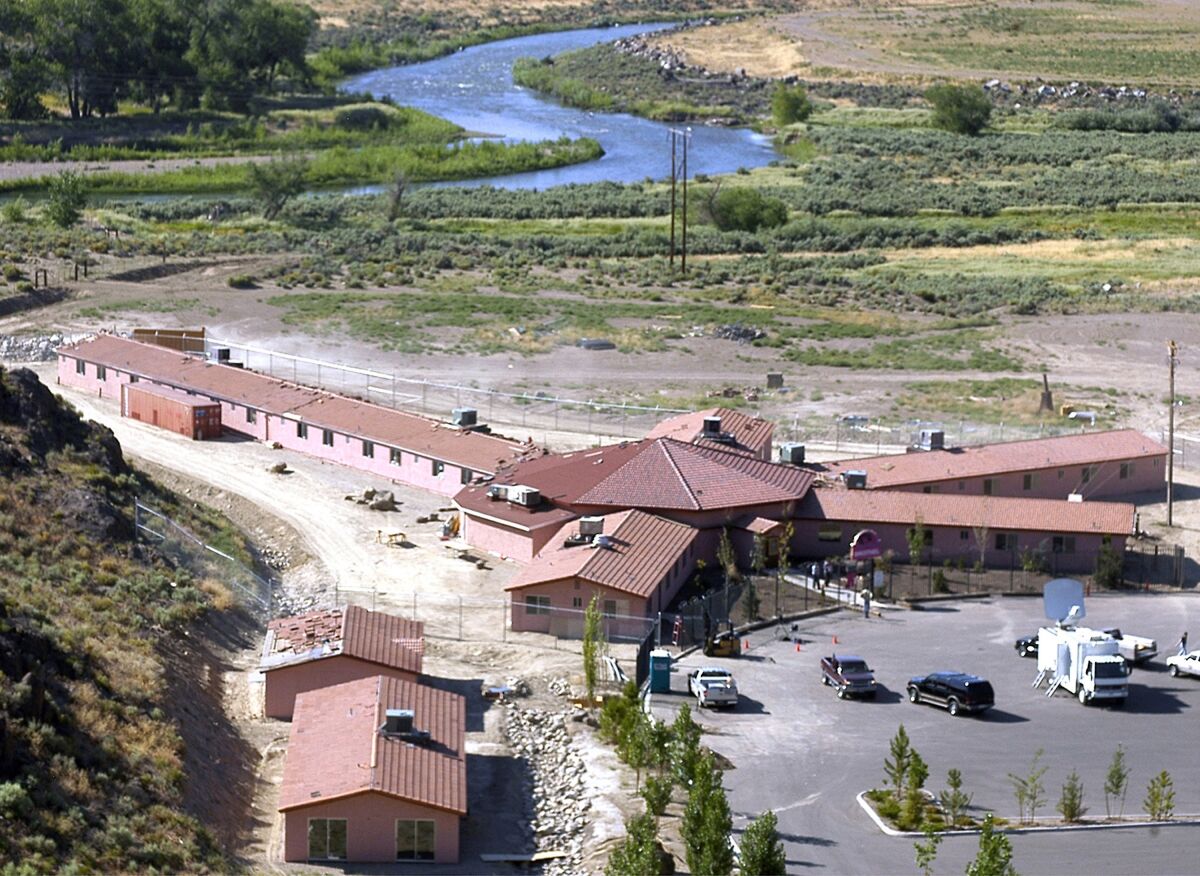 FILE - This Friday, July 1, 2005, file photo, shows the Mustang Ranch in the Truckee River canyon near Patrick, Nev. The legal brothel in northern Nevada is eligible to apply for a small business grant under a federal coronavirus relief package, county officials have decided. The Mustang Ranch, the only brothel in Storey County, is owned by a county commissioner, Lance Gilman. Local governments are allowed to use their share of the $150 billion in state and local government aid in the CARES Act to offer grants reimbursing businesses for costs related to the pandemic and the shutdown. (AP Photo/Debra Reid, File)