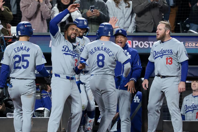 NEW YORK, NEW YORK - OCTOBER 16: The Los Angeles Dodgers celebrate a two-run home run.