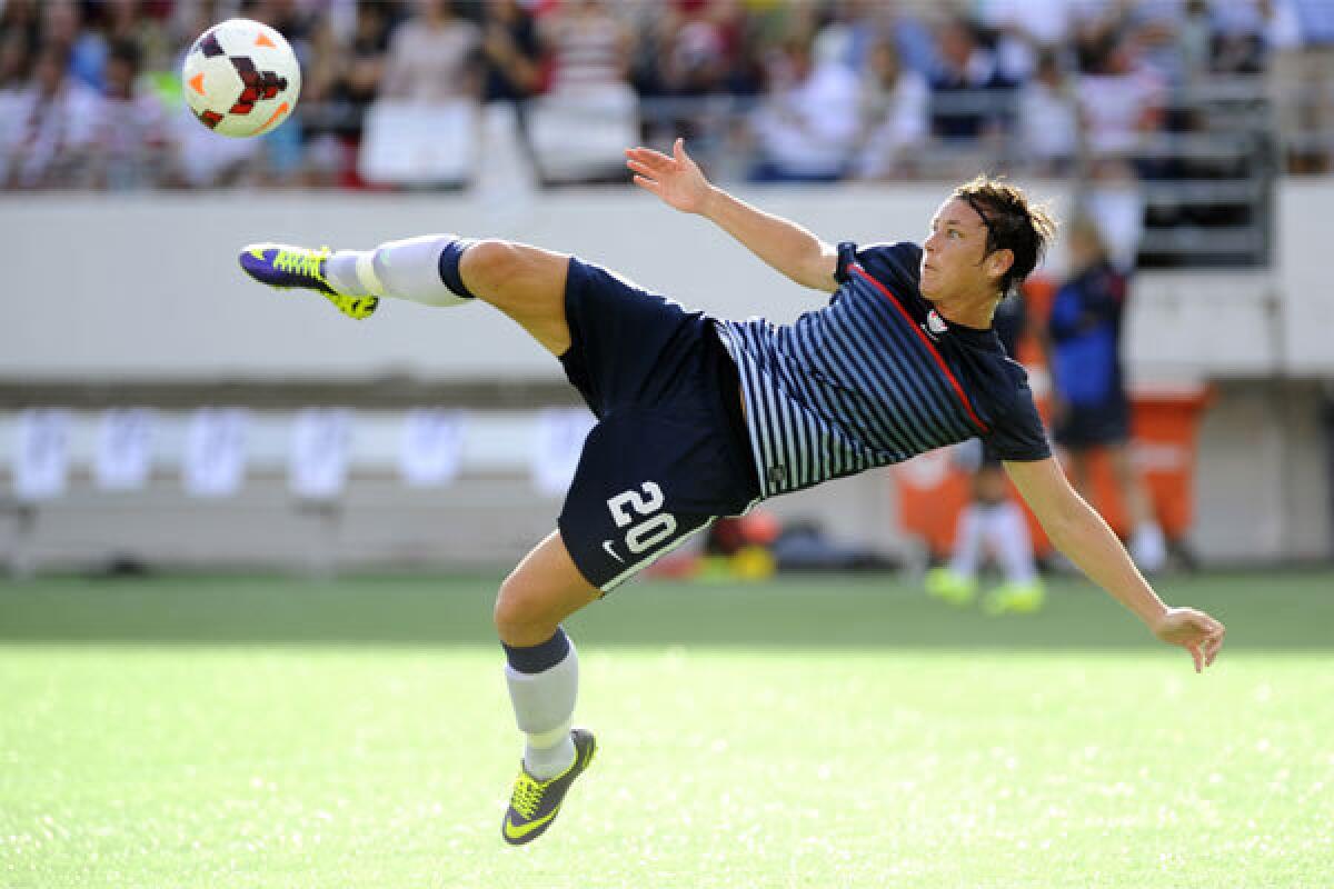 U.S. forward Abby Wambach takes a warm-up shot before the American team plays Brazil at Florida Citrus Bowl Stadium in Orlando.