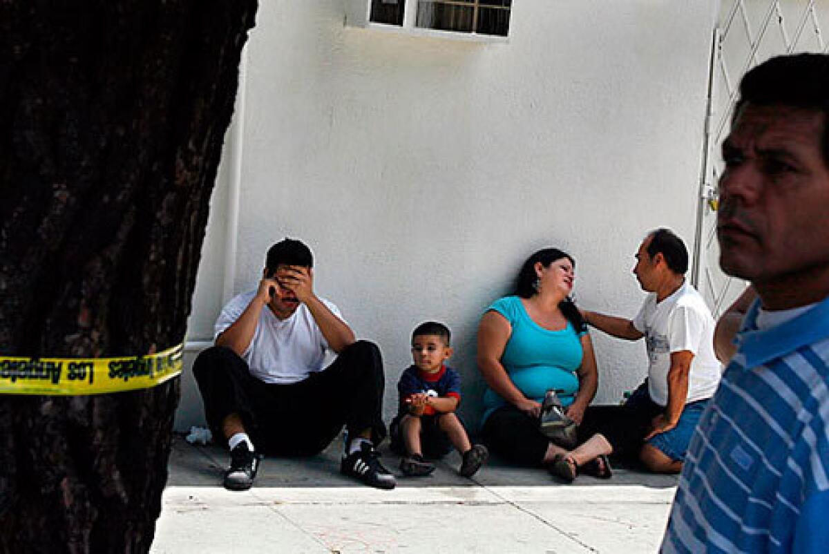 Family and friends of Ivan Valencia grieve, 30, after learning he had been shot to death at the corner of 55th Street and Broadway, near his home, on July 17. Five gangs operate in or near Valencia's South L.A. neighborhood, but he belonged to a gang whose turf is seven miles away.