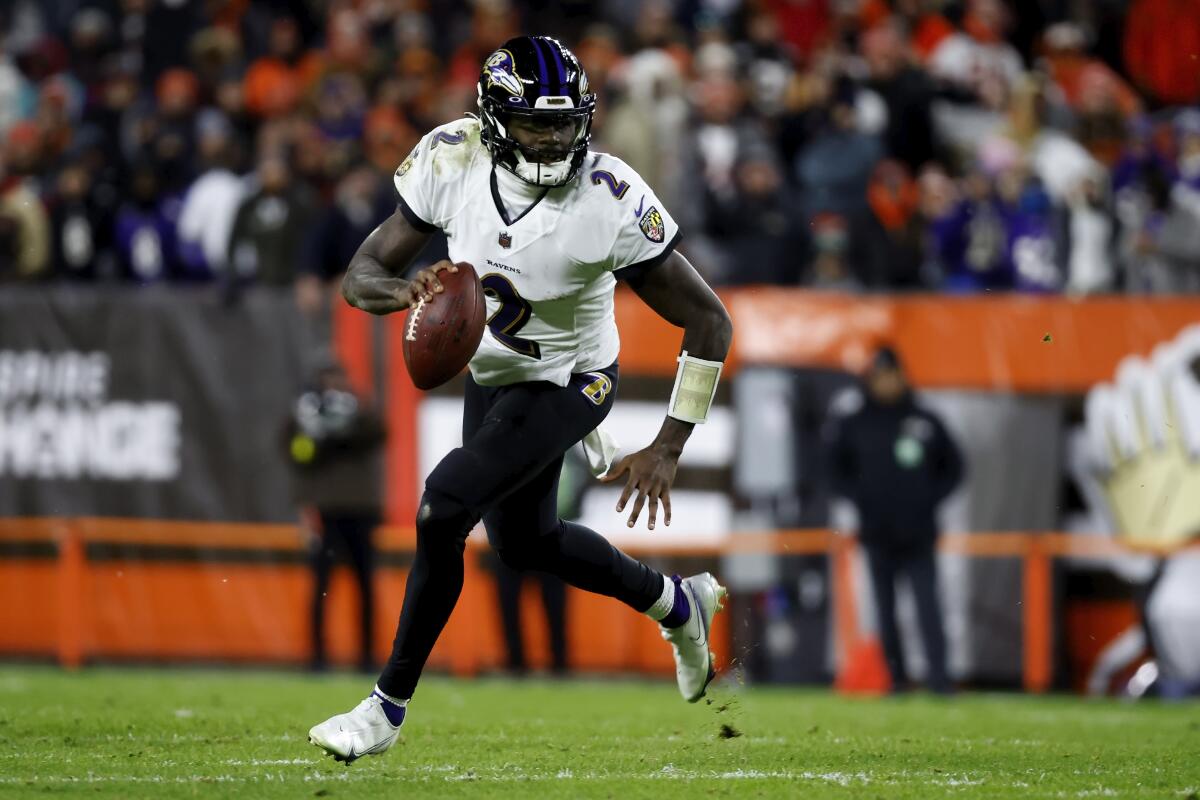 Baltimore Ravens quarterback Tyler Huntley runs with the ball against the Cleveland Browns.