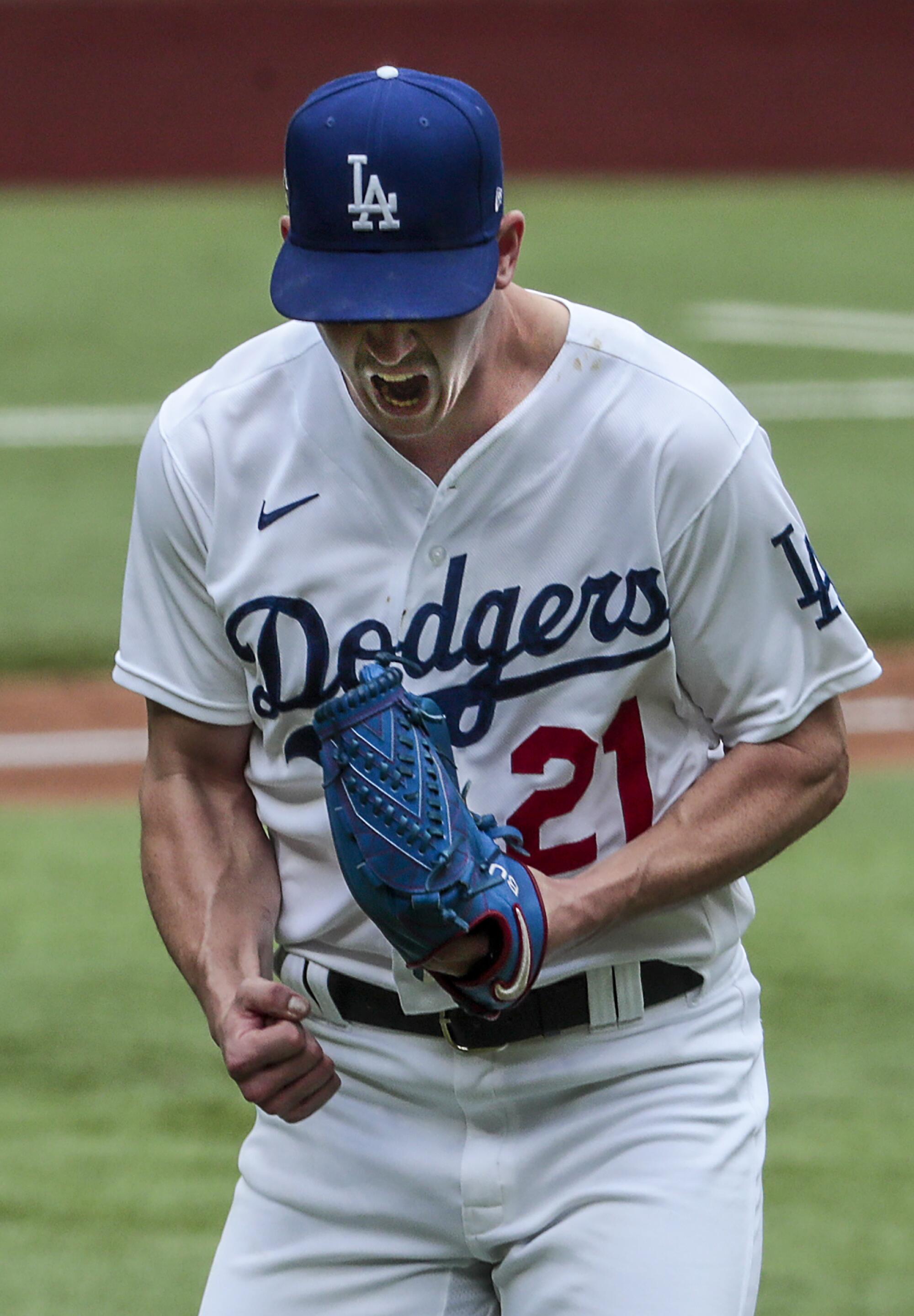 Dodgers starting pitcher Walker Buehler lets out a yell after retiring Atlanta's Cristian Pache with bases loaded in Game 6.
