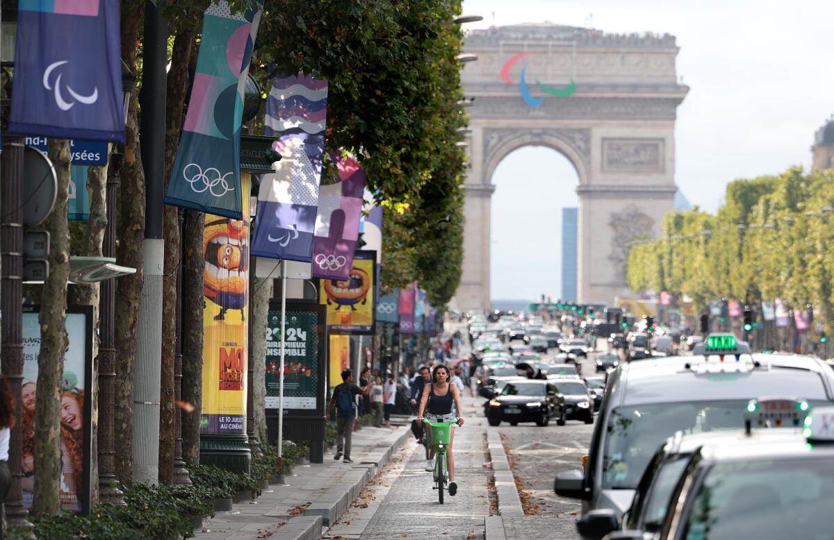 Cyclists ride along the Champs-Élysées in Paris.