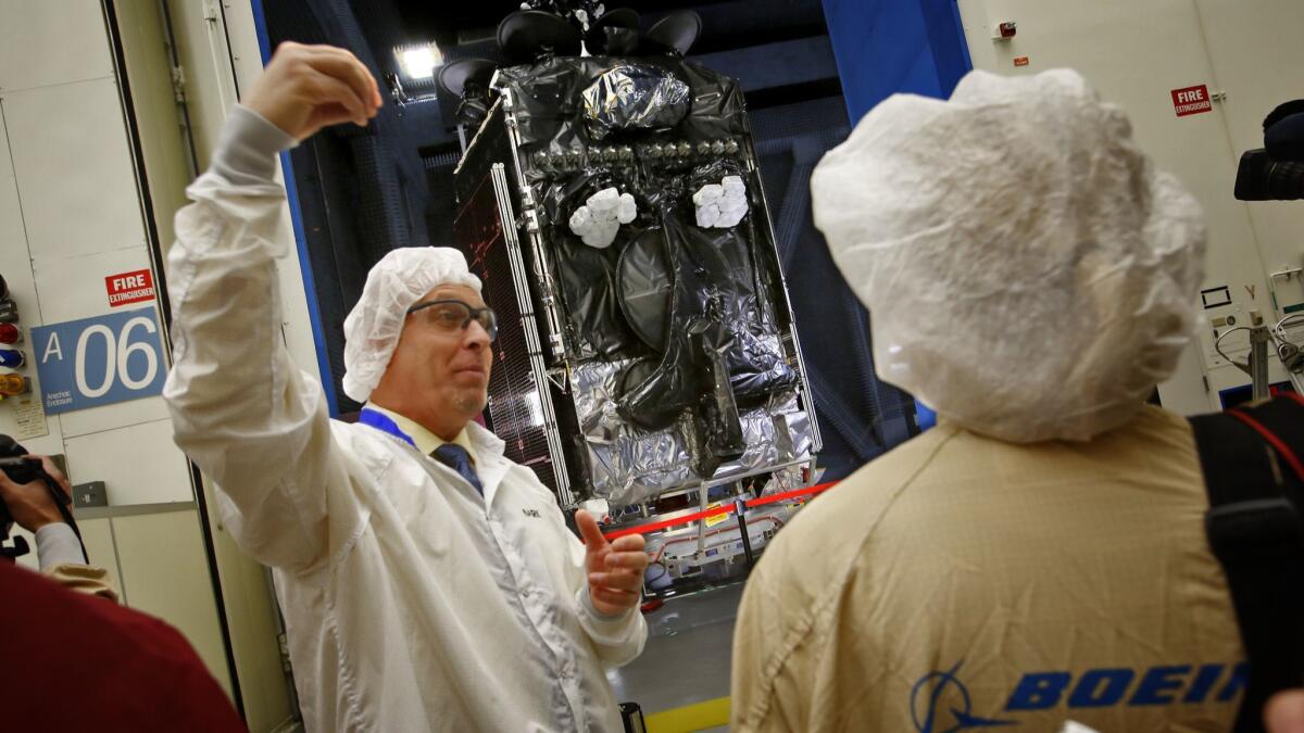At Boeing's satellite building facility in El Segundo, Mark Spiwak talks about a new Inmarsat-5 geostationary communications satellite that stands in a test chamber in 2015.