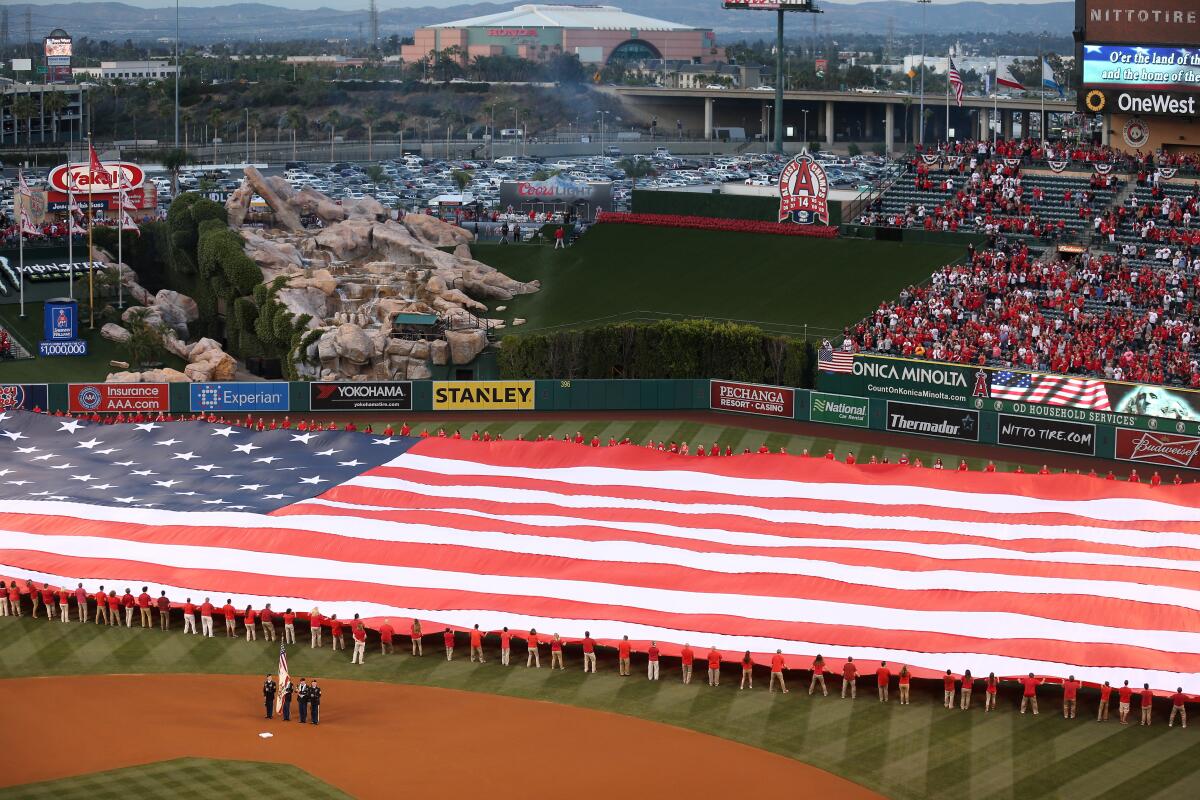 ANAHEIM, CA - APRIL 10: A color guard and a giant American flag are on the field during the national anthem before the Kansas City Royals and the Los Angeles Angels of Anaheim play in the Angels home opener at Angel Stadium of Anaheim on April 10, 2015 in Anaheim, California. (Photo by Stephen Dunn/Getty Images) ORG XMIT: 538577199