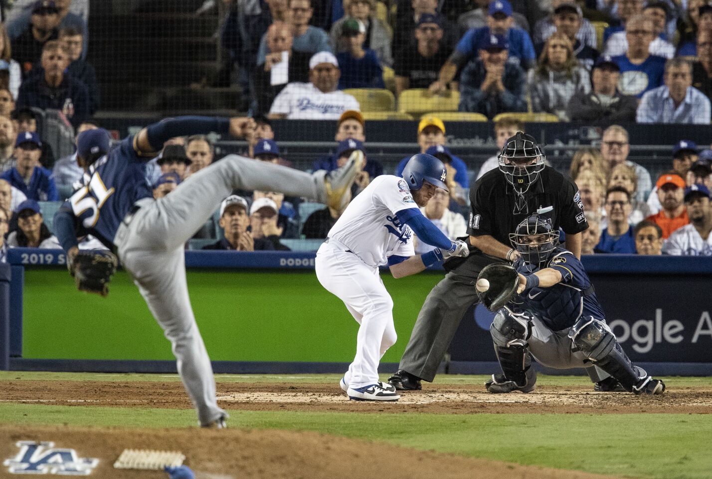 Dodgers first baseman Max Muncy is called-out on strikes with the bases loaded against Brewers pitcher Freddy Peralta in the second inning.
