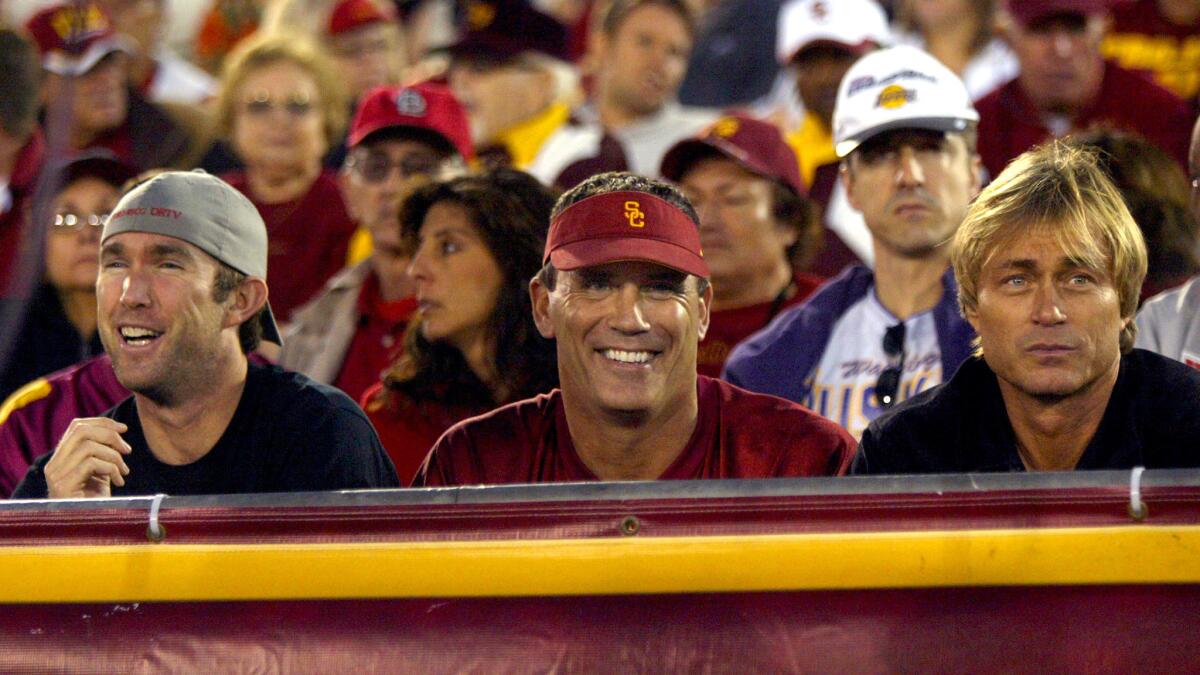 Former Trojan football player Riki Ellison watches USC play Washington during a Pac-12 game at the Coliseum.