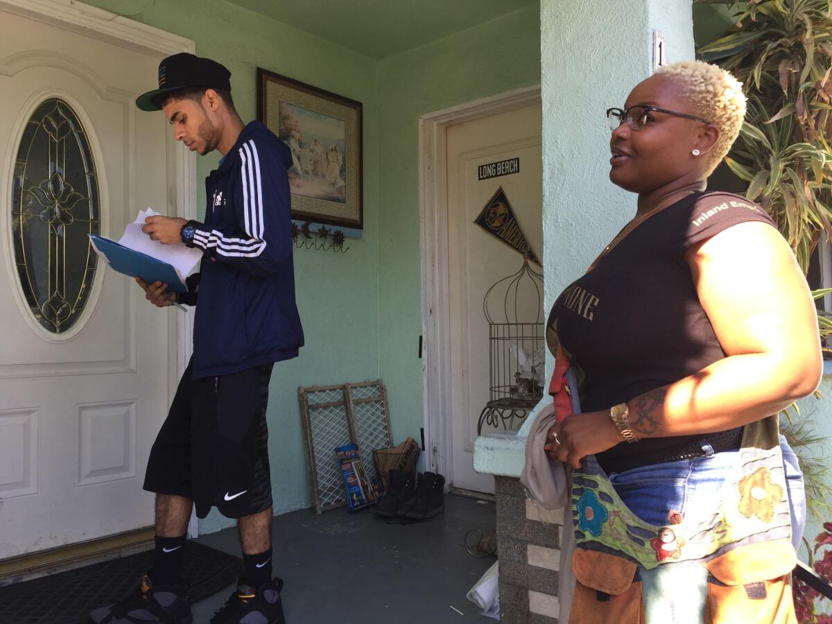 Wendell Sherman, left, of Long Beach Rising and Amber-Rose Howard of All of Us or None and A New Way of Life canvass Nov. 5 in Long Beach. Howard asked voters to support Proposition. 64, the pot legalization measure. Sherman focused on Propositions 55, 56 and 57.