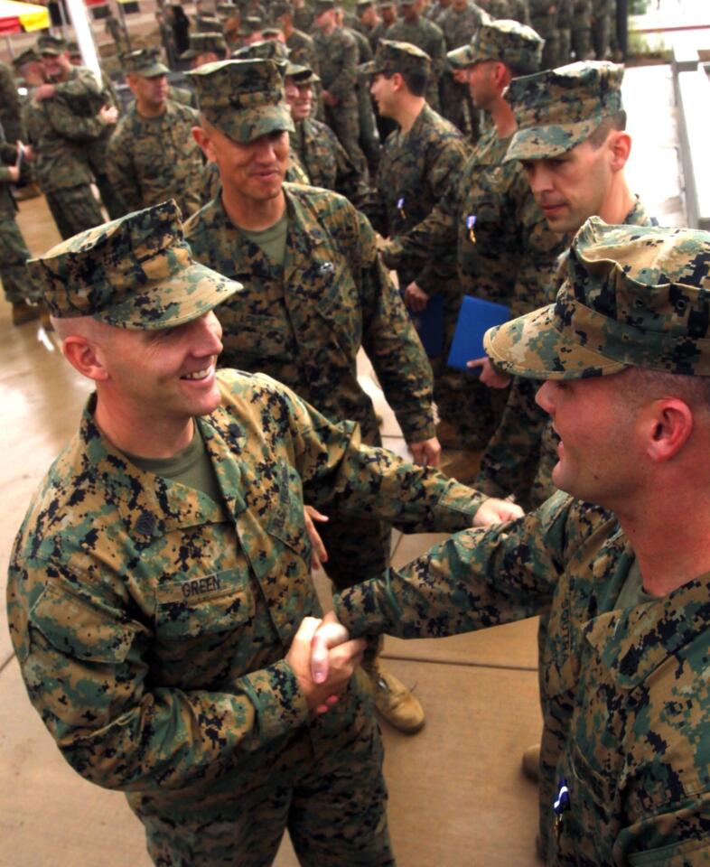 Marine Sgt. William B. Soutra, right, is congratulated by fellow Marines after being awarded the Navy Cross during ceremonies at the 1st Marine Special Operations Battalion at Camp Pendleton.