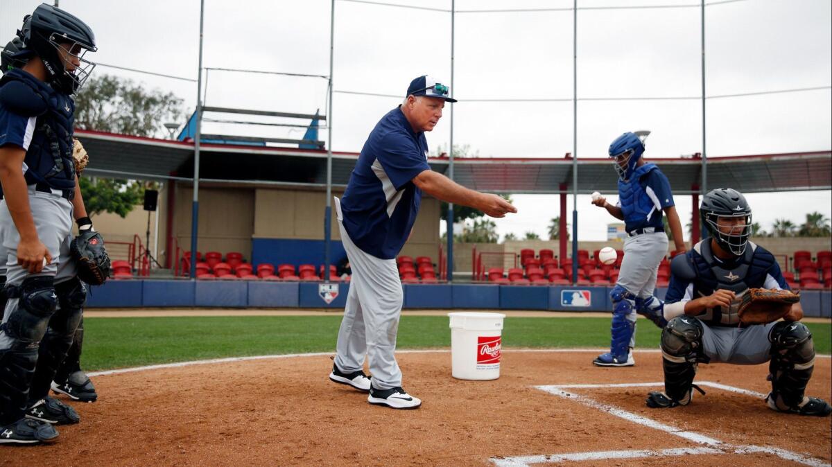 “I love the beauty of playing this game a certain way," says Mike Scioscia, shown running a catching drill at the Major League Baseball Youth Academy.