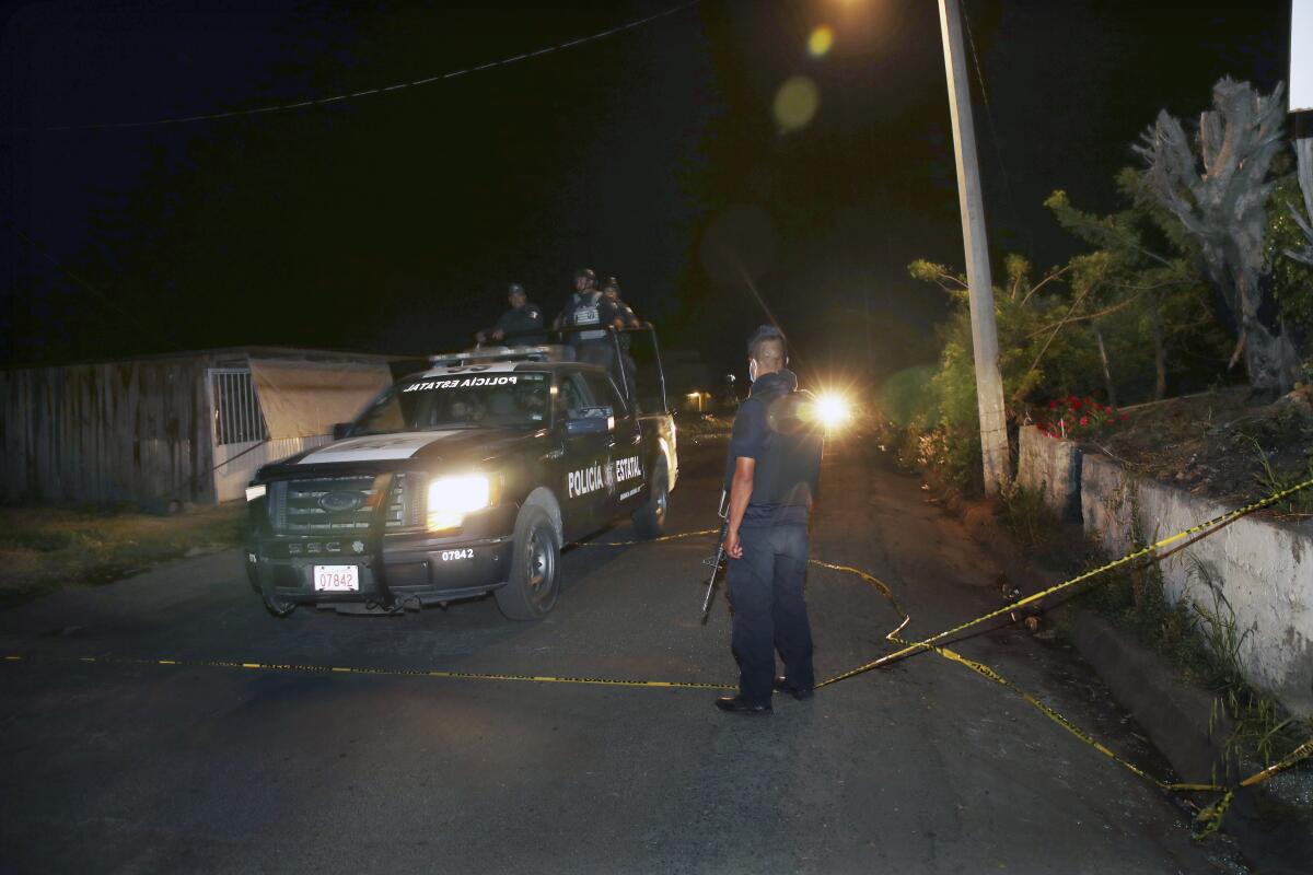 A police vehicle drives down a street. 