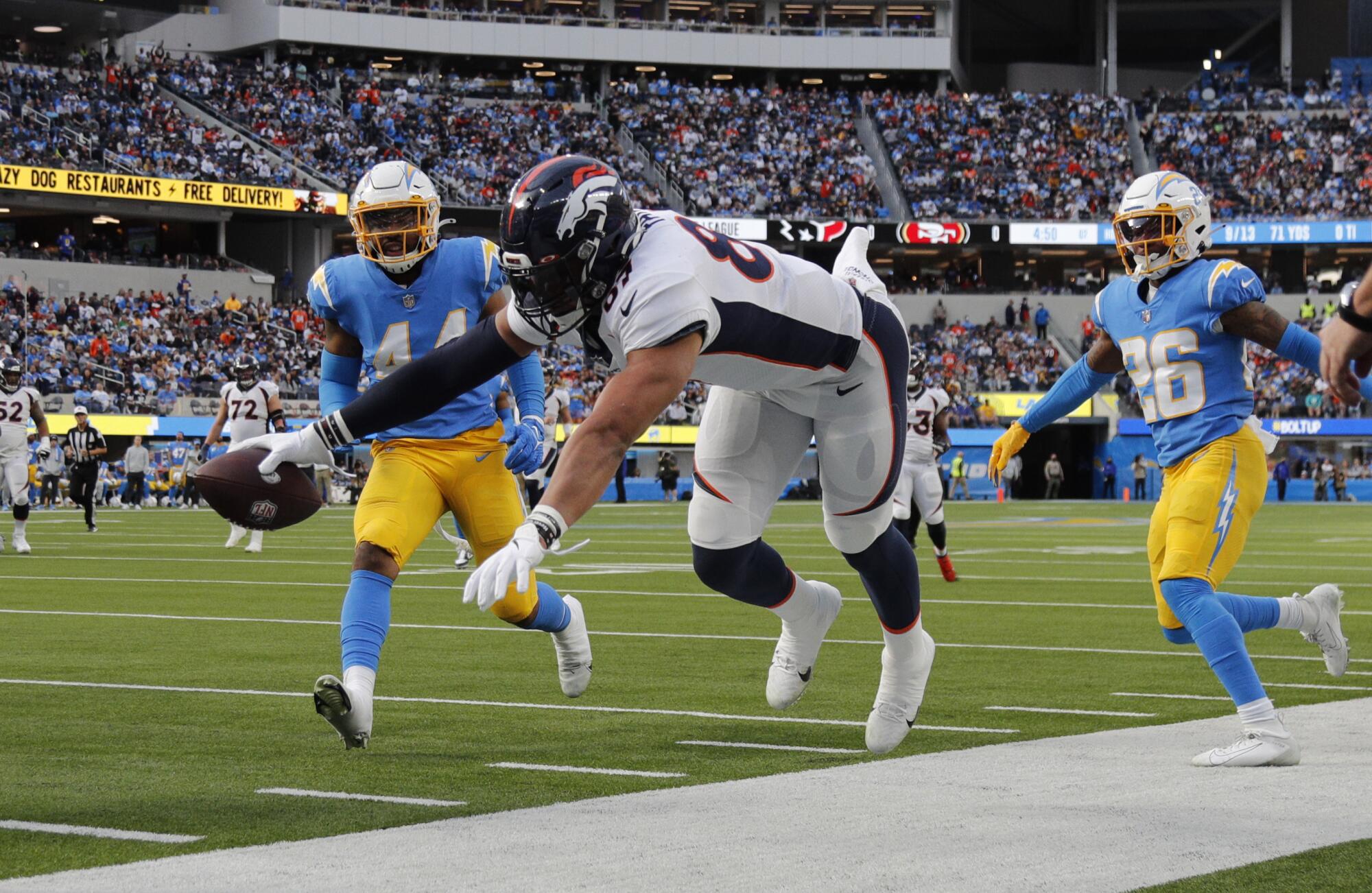 Denver Broncos tight end Noah Fant is forced out of bounds as he reaches for the goal line.