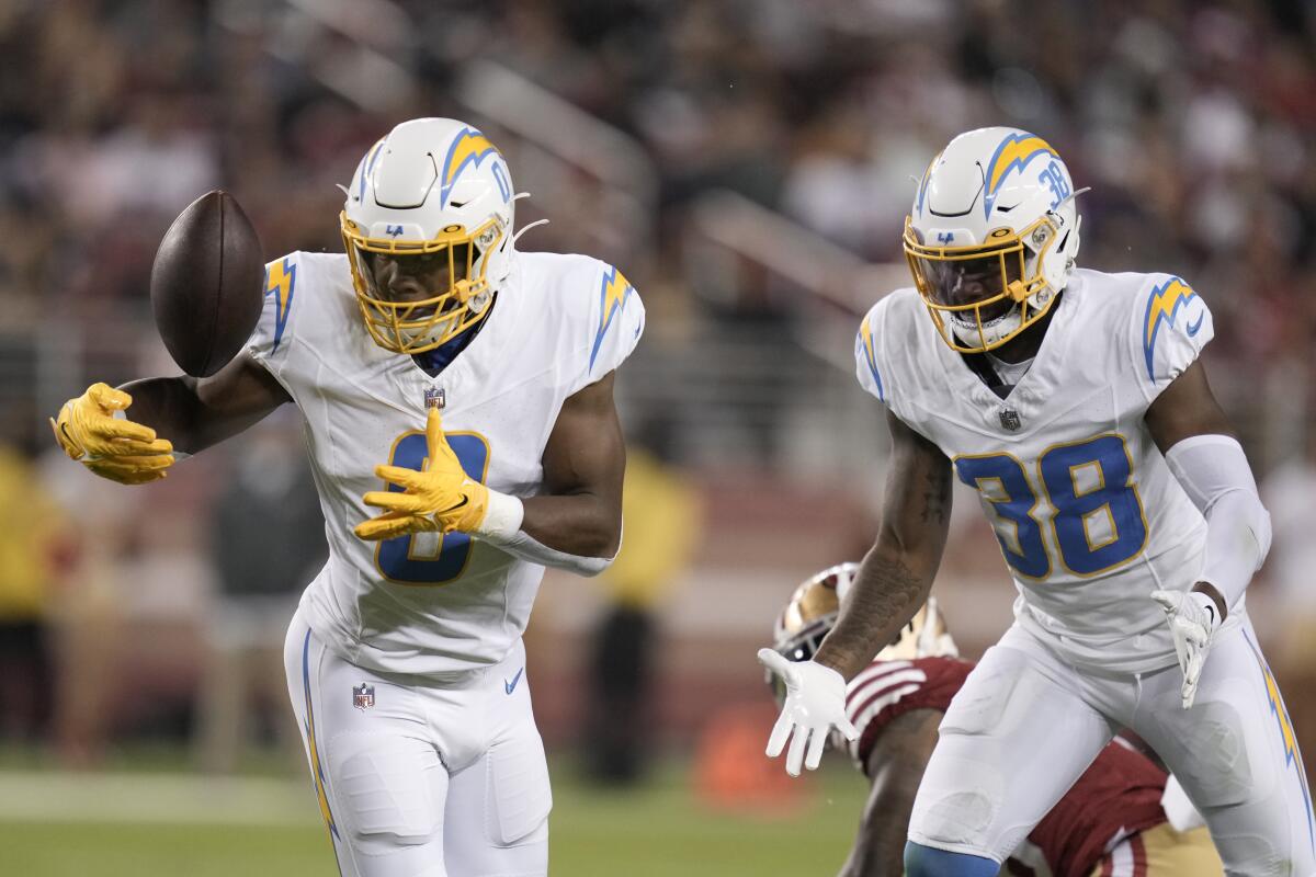 Chargers linebacker Daiyan Henley, left, intercepts a pass during the second half against the San Francisco 49ers.