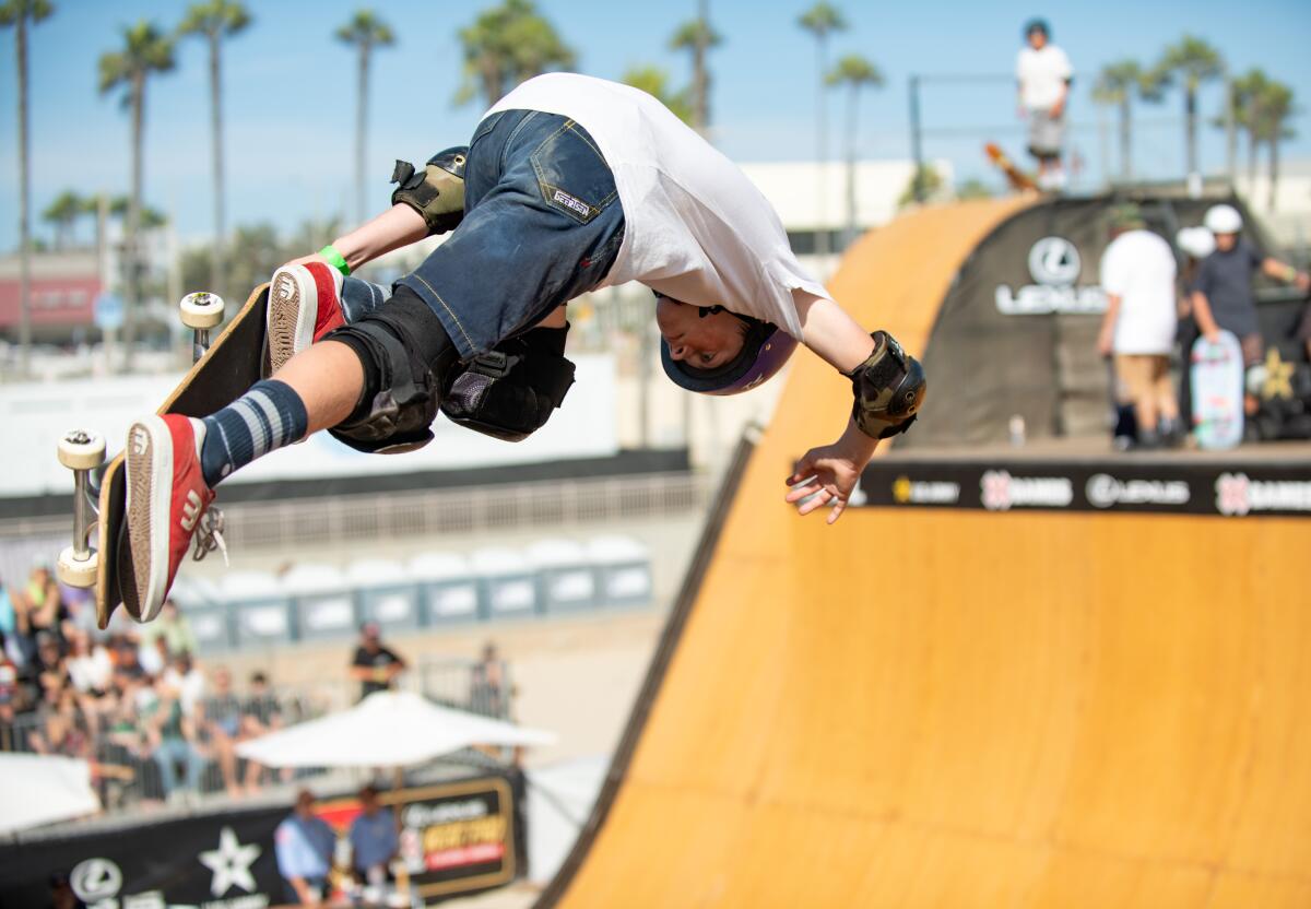 Skaters demonstrate their skills on a vert ramp built on the sand just south of Huntington Beach Pier Sunday, Aug. 3.