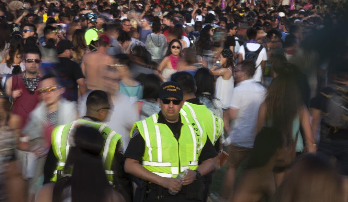 Cathedral City police officers keep an eye on the crowds of festivalgoers at the Coachella Valley Music and Arts Festival in 2015.