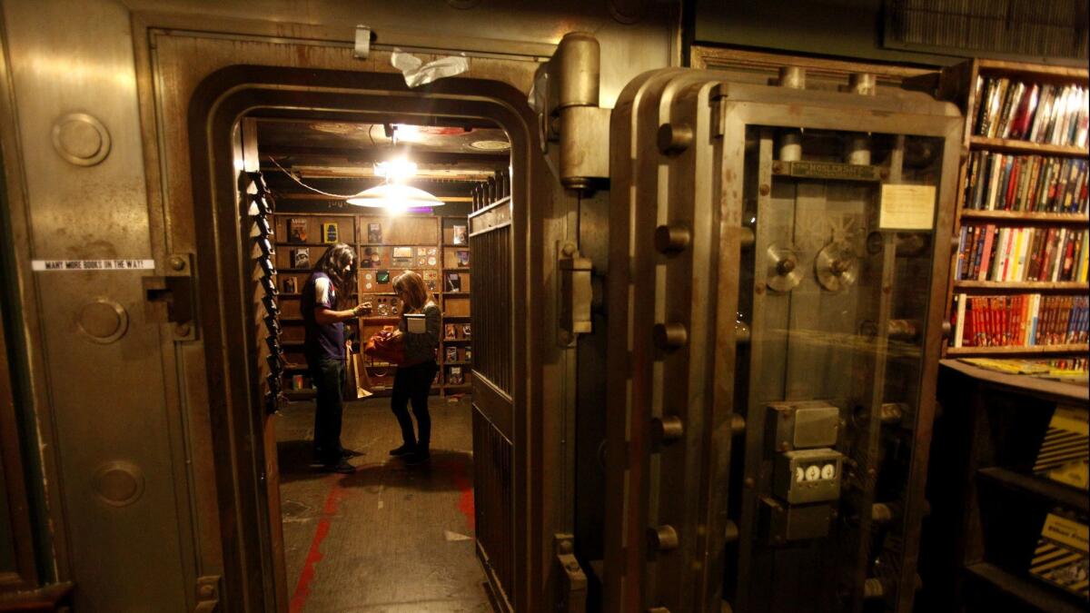 A couple spend time in the science fiction room housed inside an old bank vault on the second floor of The Last Bookstore in Los Angeles on Jan. 31, 2013.