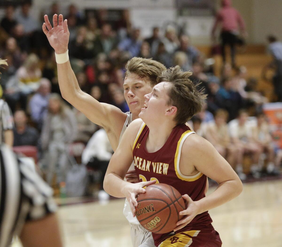 Ocean View’s Slater Miller drives in for a layup against Laguna Beach on Feb. 12.