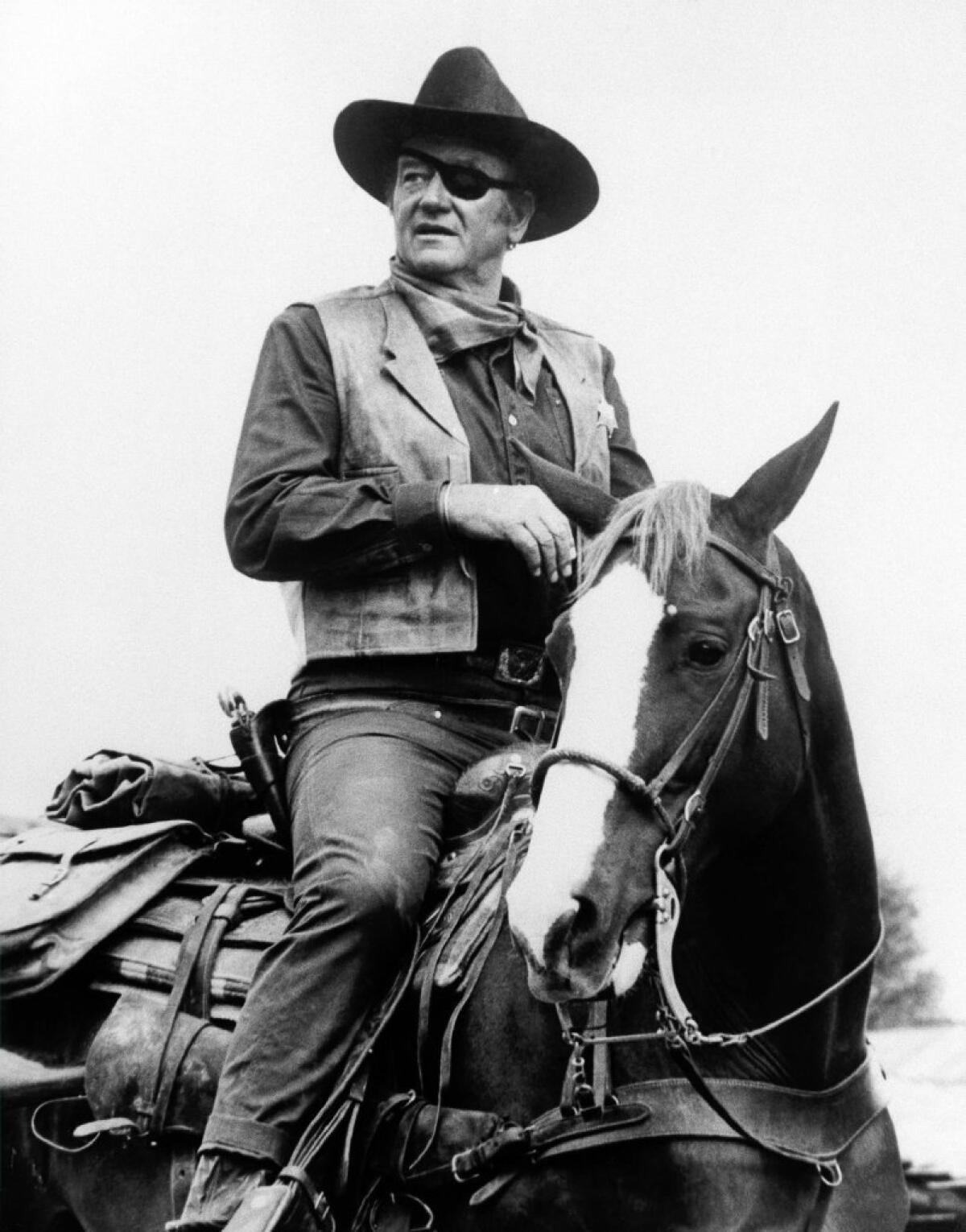 John Wayne, in his Oscar-winning role in the 1969 film "True Grit." His daughter's name is being falsely appended to an email circulating about President Obama.