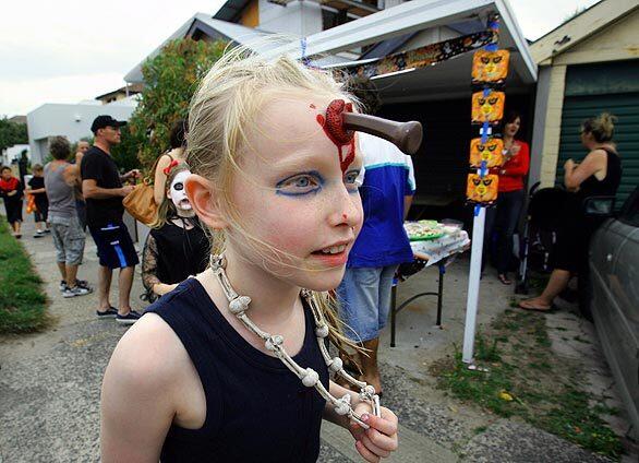 A girl goes trick-or-treating in Sydney, Australia.