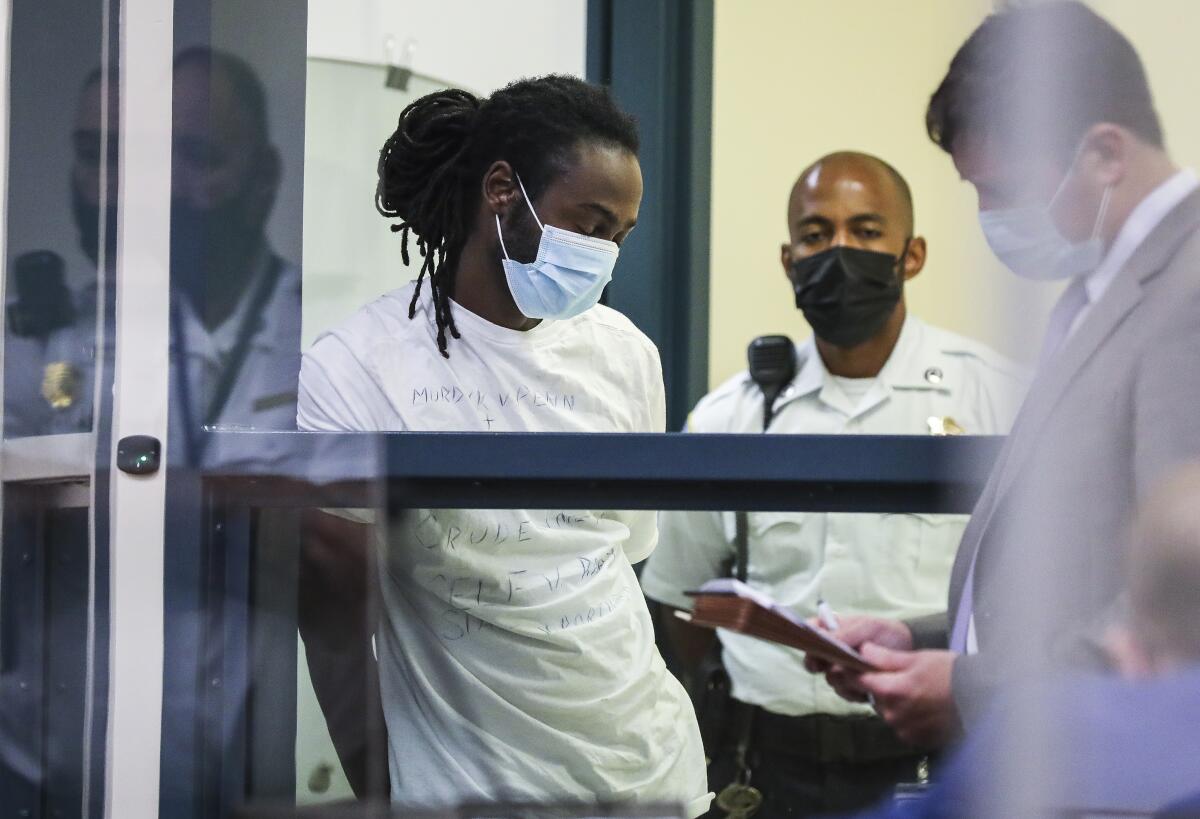 Conald Pierre is arraigned at the Malden District Court on Wednesday, July 7, 2021 in Medford, Mass. Pierre is one of 11 people charged in connection with an armed standoff along a Massachusetts highway last weekend. (Erin Clark/The Boston Globe via AP, Pool)