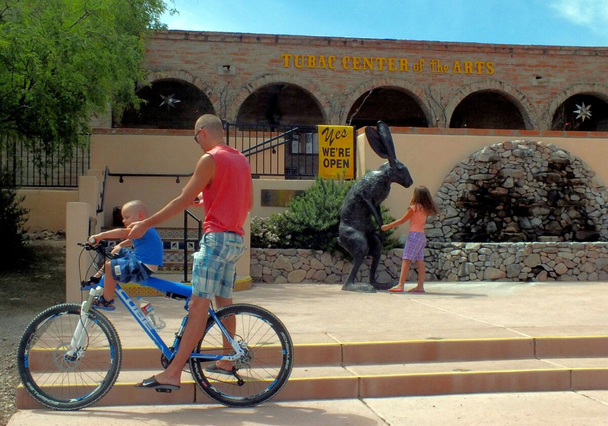 A whimsical sculpture strikes a child's fancy outside the Tubac Center of the Arts.